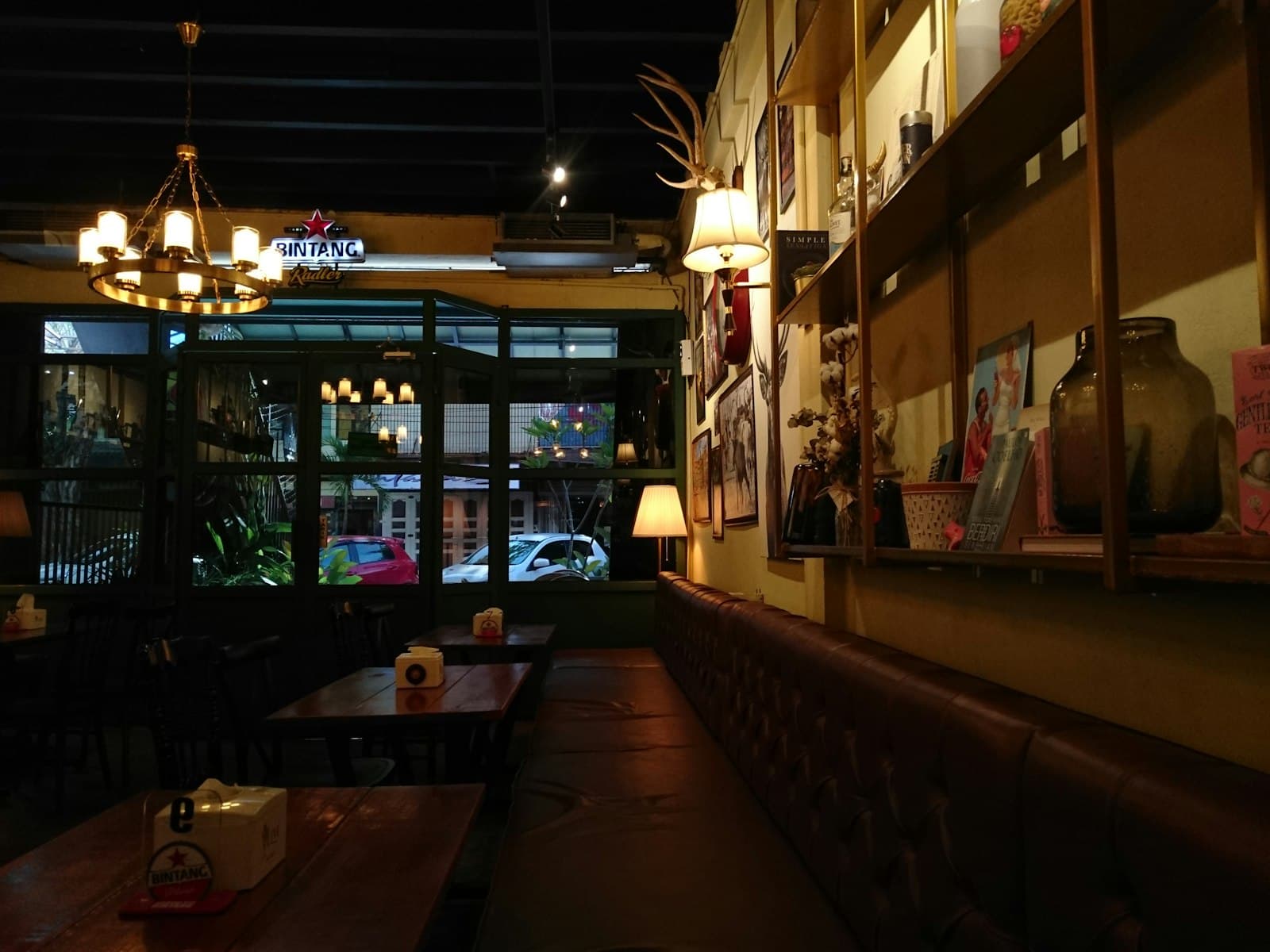 A warm, low-lit neighbourhood restaurant with a window onto the street.